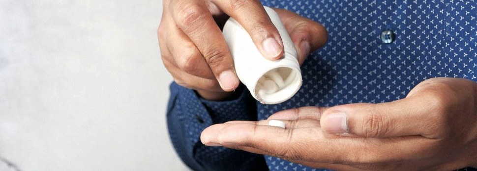 Man pouring ED Pills into hand