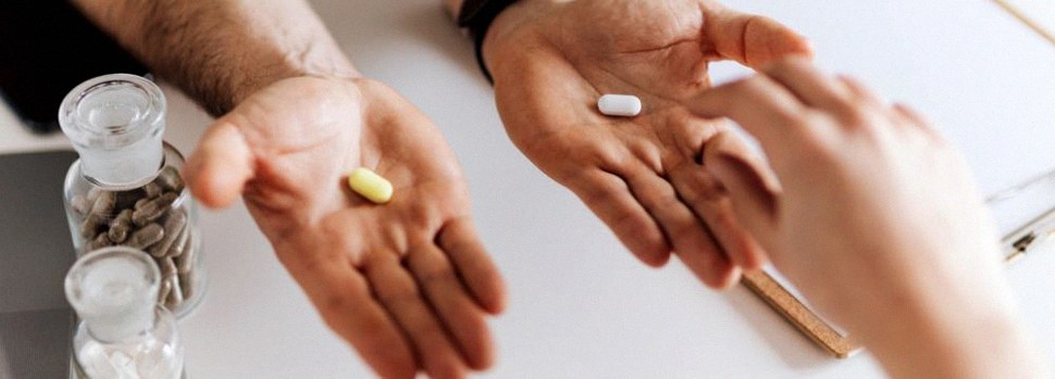 Man holding nitric oxide supplements in both hands